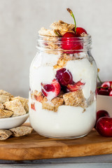 Bitesize shredded wheat with fresh cherry berries in Jar