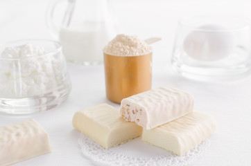 protein products such as whey powder, snack bar and egg with milk and curd