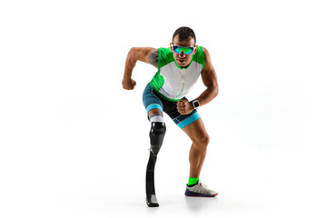 Athlete with disabilities or amputee isolated on white studio background. Professional male runner with leg prosthesis training and practicing in studio. Disabled sport and healthy lifestyle concept.