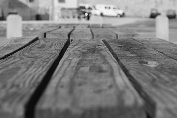 Wooden Picnic Table Outside On Sunny Morning with Hard Shadows without people or food on concrete...