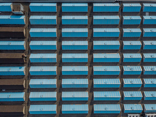 Aerial view of roof of industry building with regular pattern of windows