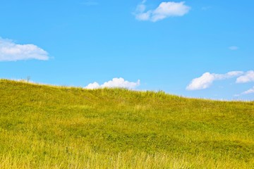 The slope of the mountain against the blue sky.Picturesque meadow.