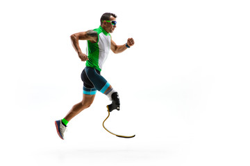 Fototapeta na wymiar Athlete with disabilities or amputee isolated on white studio background. Professional male runner with leg prosthesis training and practicing in studio. Disabled sport and healthy lifestyle concept.