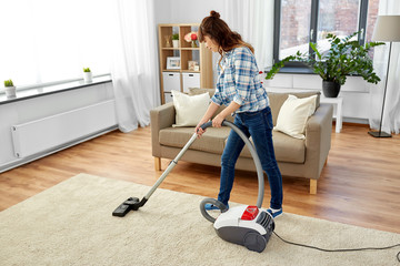 household, housework and cleaning concept - asian woman or housewife with vacuum cleaner at home