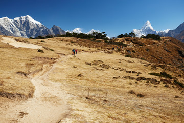 Himalayas mountain landscape. A steep snowy peak and a vast valley on a beautiful sunny day.