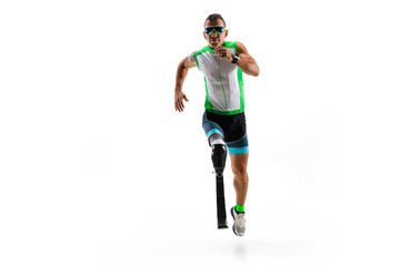 Athlete with disabilities or amputee isolated on white studio background. Professional male runner with leg prosthesis training and practicing in studio. Disabled sport and healthy lifestyle concept.