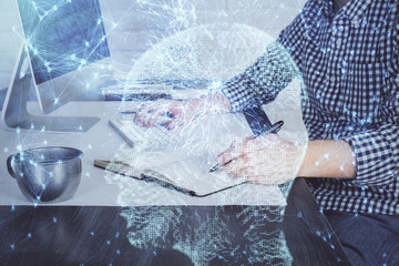 Man typing on keyboard background with brain hologram. Concept of big Data. Double exposure.