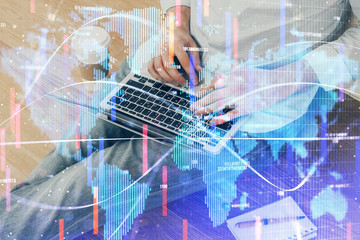 Double exposure of businessman working on laptop on background. International business hologram in front. Concept of success.