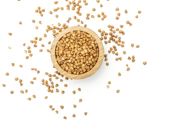 Lot of whole raw brown buckwheat grain in a wooden bowl flatlay isolated on white background