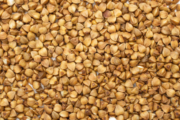 Lot of whole raw brown buckwheat grain macro flatlay isolated