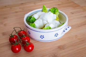 Composition of tomatos, salad and cow's milk mozzarella cheese handmade in Puglia, Italy