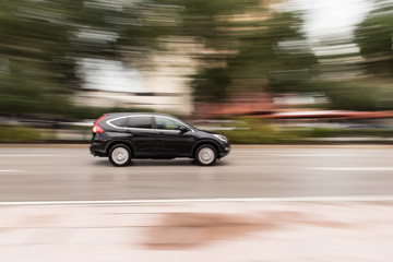 Fototapeta na wymiar Motion Blur of Car Speeding Down a City Street