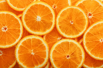 Round orange slices, in the form of texture and lanterns of fresh juicy slices