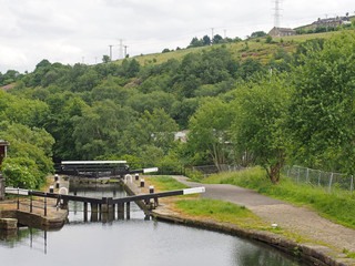 wooden lock gates on the calder hand hebble navigation canal in front of the basin in sowerby...