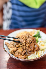 braised pork on rice on table