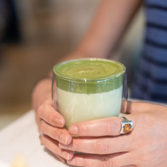 cup of matcha milk tea on table