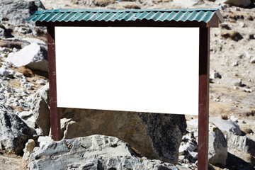 Information board made of wood, in the background a rocky mountain slope. © KielaRob