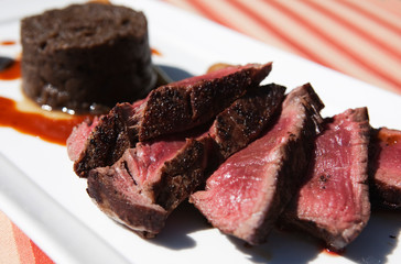 slices of chateaubriand with a mushroom pudding