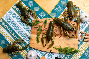 live crayfish on a wooden board