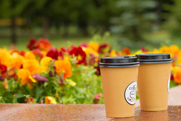paper cups with coffee in the fresh air