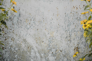 Distressed grunge background with wild flowers on the sides. Old metal with rusty texture, copy space for inserting text.