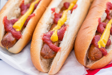 Hot dogs with ketchup and mustard, close-up view. Typical american fast food: hotdogs served and ready to eat