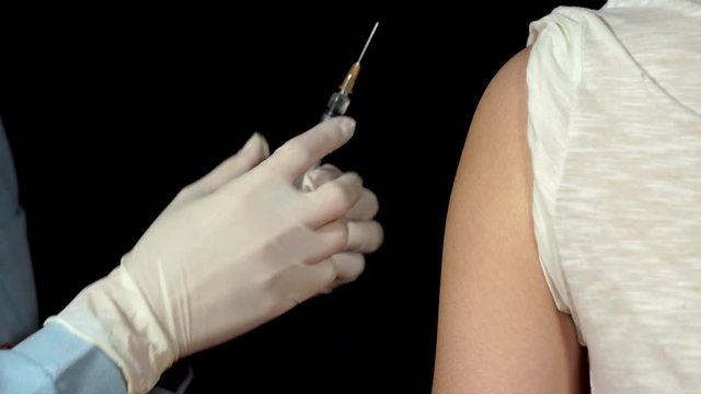 doctor or nurses are vaccination to patient using the syringe injected upper arm