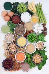 Health food  high in protein with dairy, legumes, bean curd, vegetables, dried fruit, grains, supplement powders, seeds and nuts. Super foods high in dietary fibre, vitamins &  antioxidants. Top view.