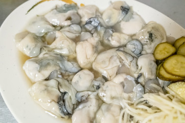 fresh oysters close-up on white plate
