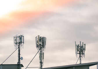 LTE, GSM, 2G, 3G, 4G, 5G tower of cellular communication. Telecommunication tower against the sky with clouds.