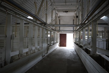 abandoned building. farm shelter in the barn with haystacks.  Inside a Barn for Farm Animals like Cows or Horses. Interior of Old abandoned empty barn.