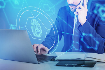 Man on phone with laptop, online security