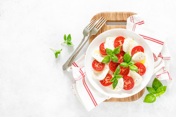 Fresh italian Caprese salad on white plate, view from above