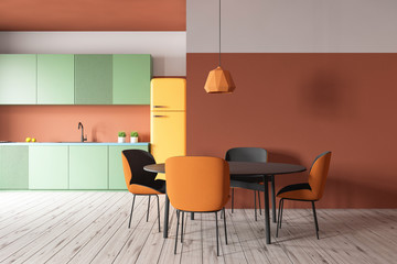 Orange kitchen with green counters and table