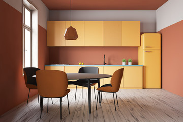 Orange kitchen interior with counters and table