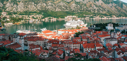 Fototapeta na wymiar Cityscape of old city Kotor, bay in Adriatic sea surrounded by mountains, Montenegro. Panoramic view from above