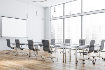 White meeting room with projection screen