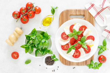 Fresh italian Caprese salad on white plate, view from above