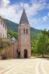 Fototapeta na wymiar Religious architecture. Montenegro, Lower Ostrog Monastery. View of Church of St. Trinity on sunny summer day