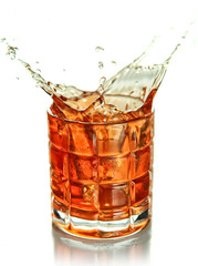 Bourbon whiskey splash in an elegant glass cut glass isolated on white background