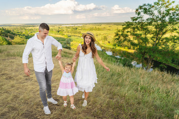 Parents are having fun with their little daughter. Family values