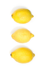 Three yellow fresh lemons isolated on white background. Vertical image.