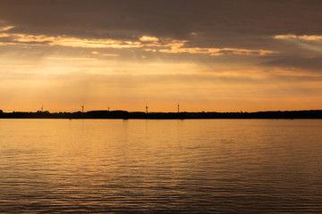 Beautiful sunset at the sea called Kattegat, with windmills in the background