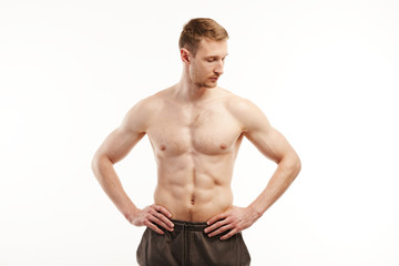 Fototapeta na wymiar Muscular man poses at the camera topless.