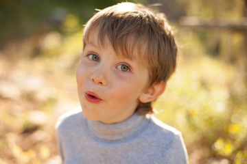 beautiful portrait of a baby boy smiling in nature for a walk