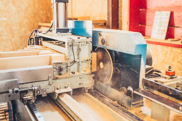Fototapeta na wymiar Powerful sawing machine with circular saw - industrial production