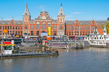 City scenic from Amsterdam with the Central Station in the Netherlands - obrazy, fototapety, plakaty