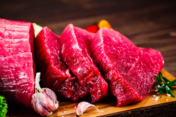 Fresh raw beef steaks on cutting board
