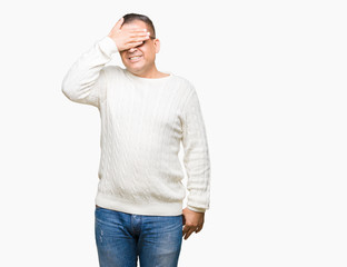 Middle age arab man wearing glasses over isolated background smiling and laughing with hand on face covering eyes for surprise. Blind concept.