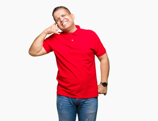 Fototapeta premium Middle age arab man over isolated background smiling doing phone gesture with hand and fingers like talking on the telephone. Communicating concepts.